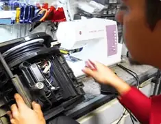 Vacuum repair technician servicing internal components on a workbench in San Diego, CA