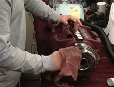 Vacuum repair technician cleaning and servicing a vacuum motor in San Diego, CA